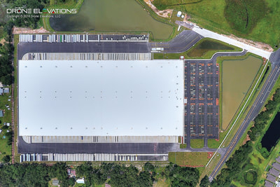 Overhead aerial drone photo of distribution center warehouse.